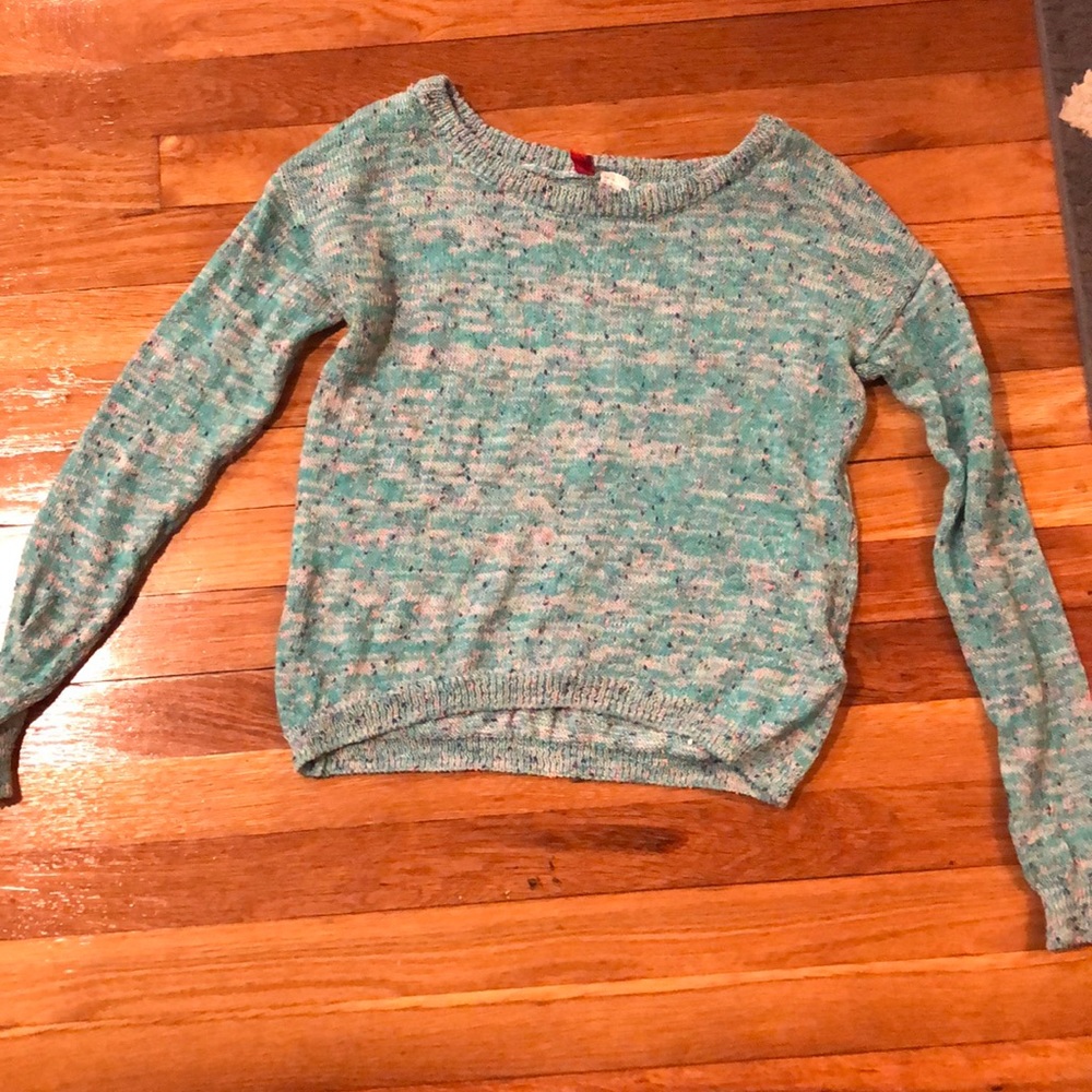 A Aqua blue teal sweater and dots of other colors.